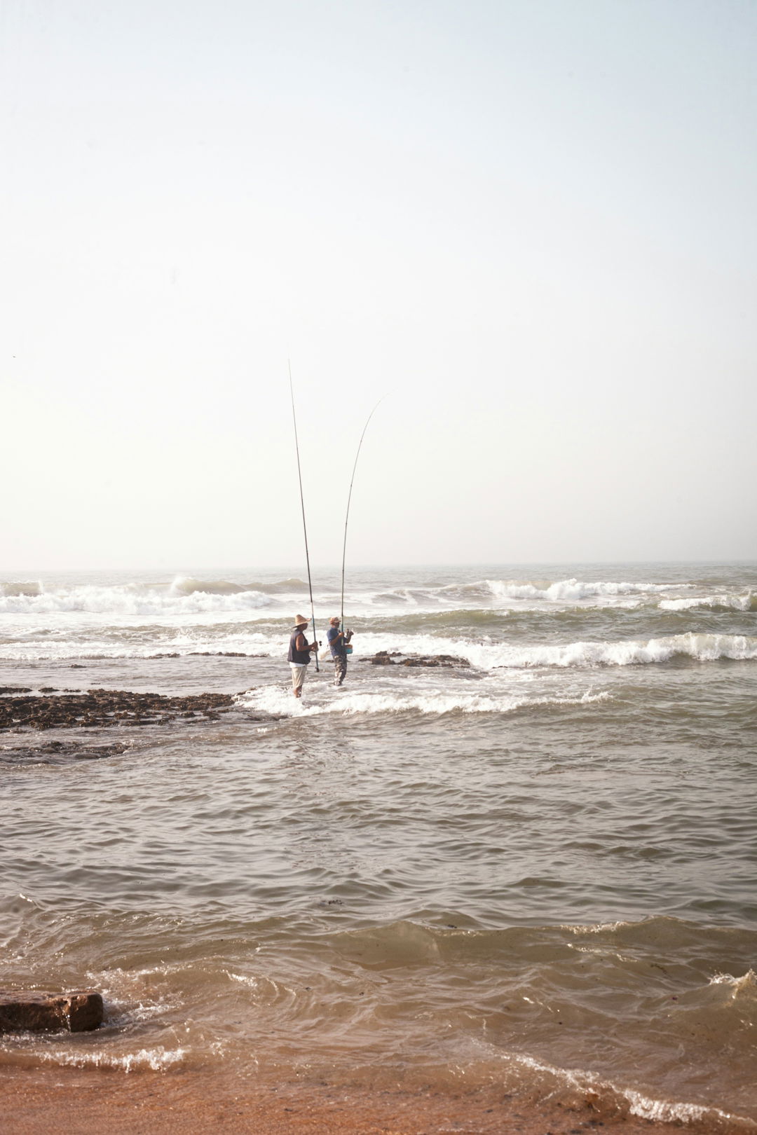 2 person surfing on sea during daytime